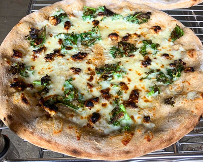 woodfired pizza with kale candied walnut and white sauce