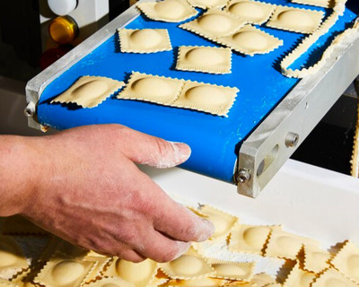 cacio e pepe fresh ravioli on the conveyor belt
