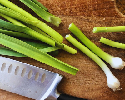 green garlic cutting board knife