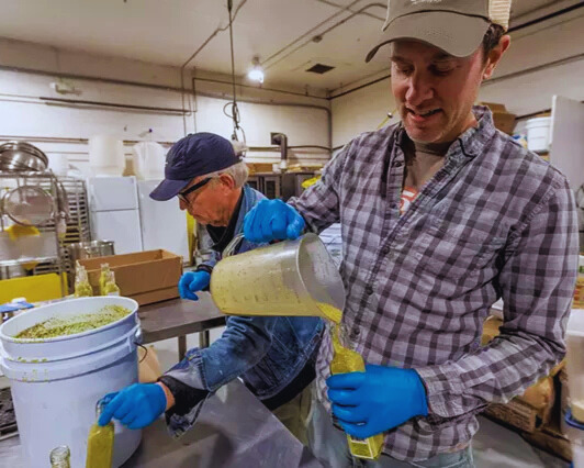 real green foods filling their dressing bottles