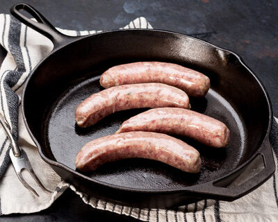 hot italian sausage links in a cast iron pan